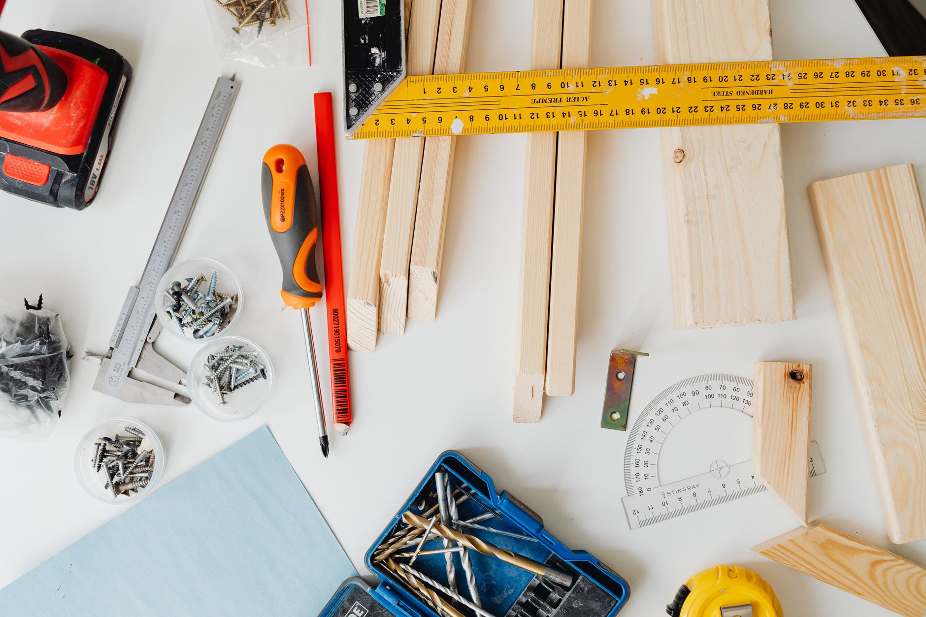 Top view of carpentry tools and wooden planks neatly arranged for a project. — examplearticle