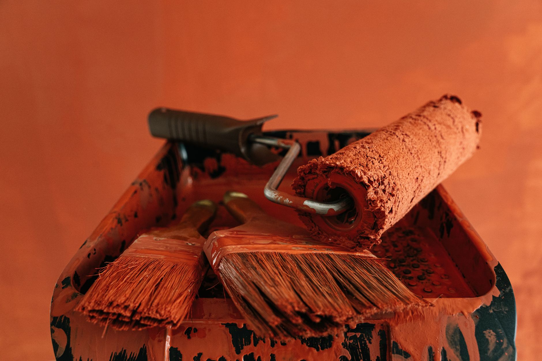 Orange paint tools in a messy tray, perfect for renovation themes. — Why You Need a Mould Remediation Specialist in Singapore