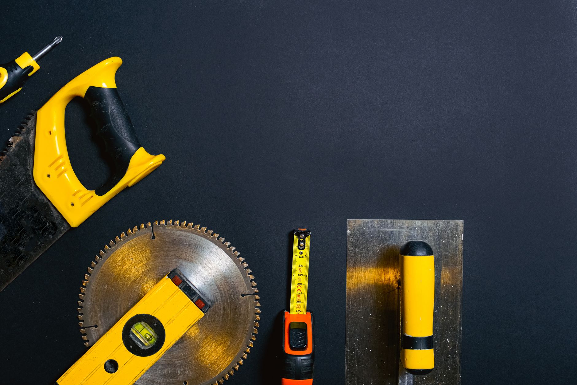 Hand tools arranged on a black surface, featuring saws, levels — "Windows in Fort Lauderdale: Balancing Style, Function, and